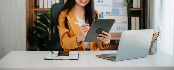 Businesswomen analyzing investment graph and discussing plan new start up project. Finance task..