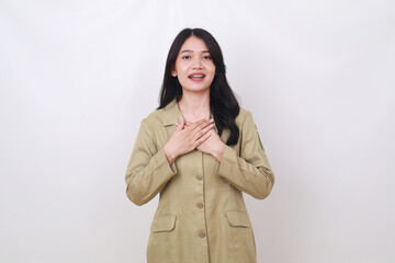 Relieved young indonesian civil servant employee standing while holding her chest