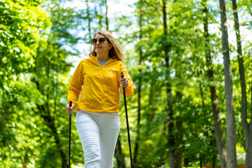 Nordic walking - woman training in city park
