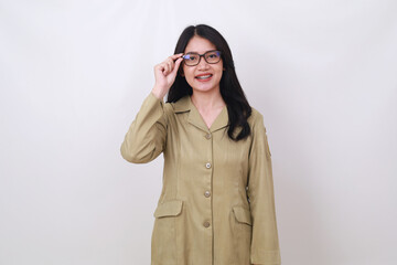 Happy Beautiful young Indonesian civil servant woman standing while holding eyeglasses