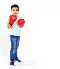 Portrait of an active boy, a novice boxer in sports gloves, highlighted on a white background. The concept of sports, movement, study, achievements, lifestyle. A place to copy ads