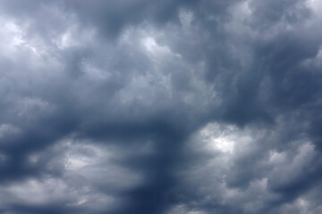 Heavy gray rainy cumulus clouds before the storm in June as background