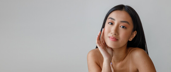 Obraz premium Young woman touching her face with perfect skin