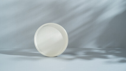 White round concrete podium on gray background with shadow. Mock up for cosmetic products and presentation. Product display.