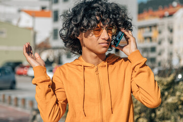 young man with worried expression and mobile phone