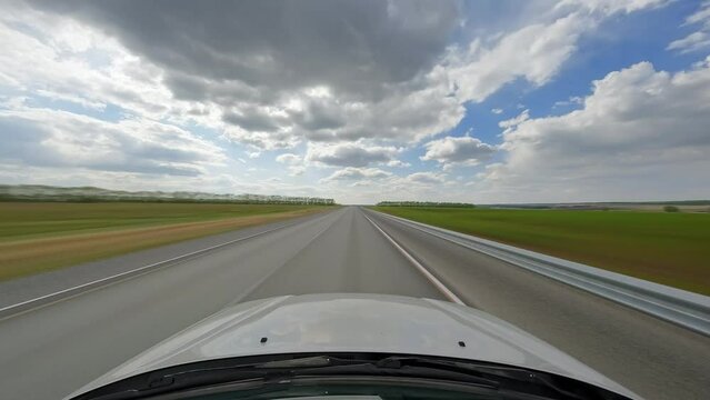 POV timelapse of Car is Driving on the two-lane Asphalt Road at Summer partly-cloudy day. 60 fps, H.264, 8bit, Chroma Subsamlping 4:4:4