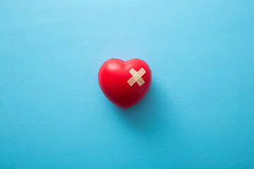 red heart with adhesive plasters, top view.