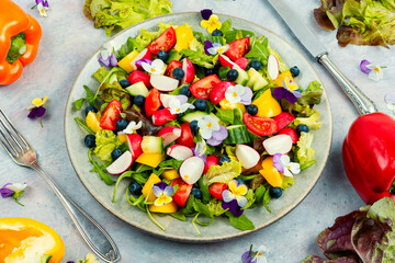 Colorful summer salad with edible flowers