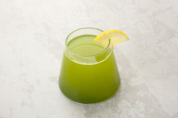 Healthy green juice (kale, pineapple and lemon) on the table. Cold pressed juice
