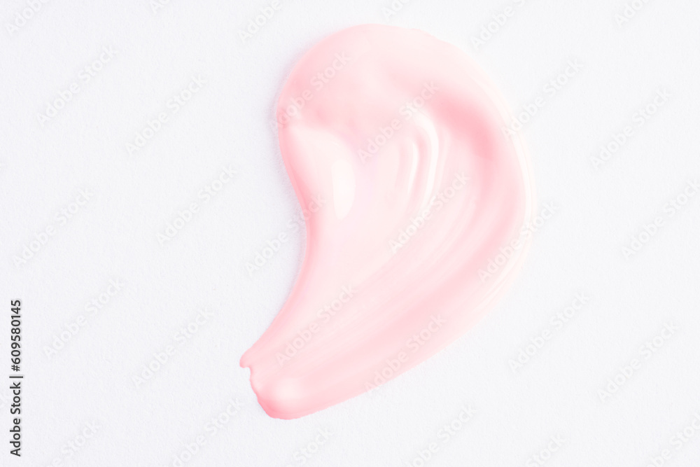 Wall mural pink cosmetic cream smear on white background. pink beauty cream smear swipe swatch closeup. skincar