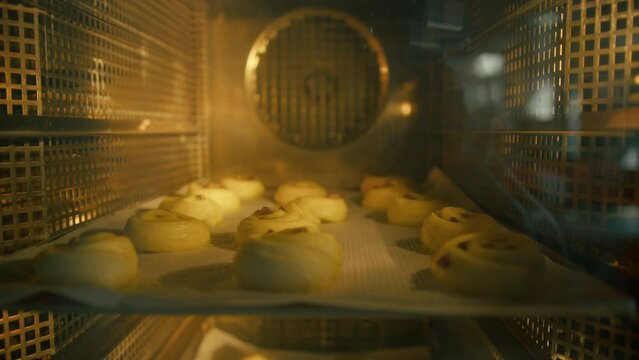 Lush crispy fragrant buns are baked in the oven in the bakery Puff pastry and flour products production