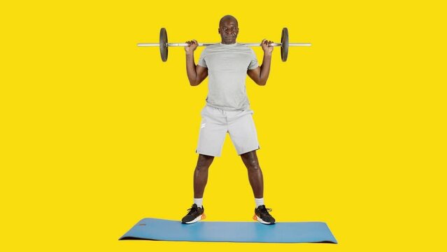 African strong man squatting with weights using a bar