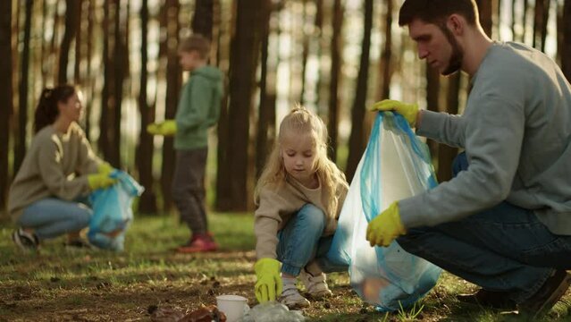 Children And Parents Volunteers Collecting Plastic Waste In Forest, Environmental Protection