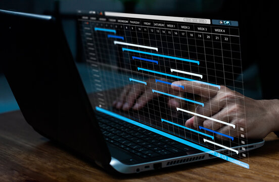 Planning and Executing, Businesspeople utilize laptop computers to update tasks and manage business projects. Work in progress and effective planning.