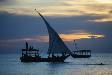 Sunset and boats in the sea, sunset on Zanzibar beach