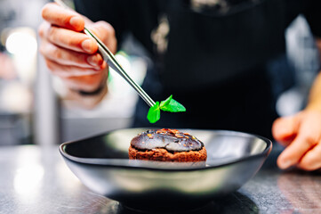 chef decorated Basque cheesecake with Chocolate and cream in bowl on kitchen