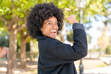 African American girl at outdoors With glasses and celebrating a victory