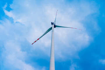 Windmill farm at the fields with beautiful blue sky