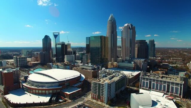 Aerial Shot Of Buildings By Spectrum Center On Sunny Day, Drone Flying Over Modern City Against Sky - Charlotte, North Carolina