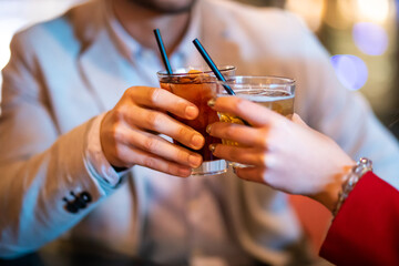 Friends toasting glasses in a disco