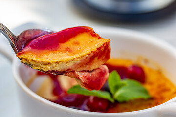 Dessert creme brulee or Catalan cream with mint leaves and berries