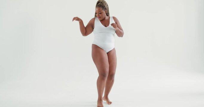 funny positive woman dancing latino, cha cha, blowing kiss Slow motion Joyful plus size woman has fun indoors Concept of body acceptance, body positivity and diversity. Love your real body.