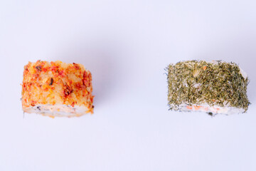 Cream cheese sushi with dill and sushi with dried tomato species on the outside.