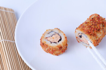 Sushi with dried tomato species on the outside.