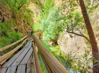 wooden walkway in mountain gorge
