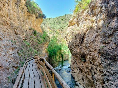 wooden walkway in mountain gorge
