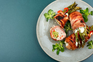 Bacon meat roll stuffed with asparagus.