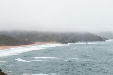 Portugal's western coastline of rocky cliffs and sandy beaches in the Odemira region. Wandering along the Fisherman trail on rainy days