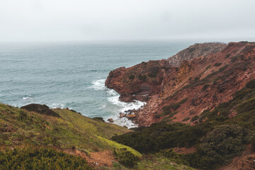Portugal's western coastline of rocky cliffs and sandy beaches in the Odemira region. Wandering along the Fisherman trail on rainy days