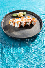 japanese cuisine sushi rolls on blue water background
