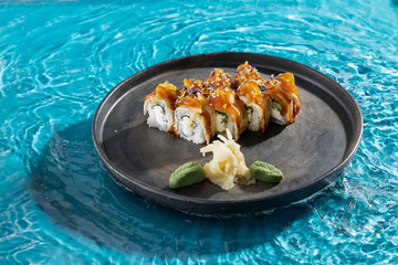 japanese cuisine sushi rolls on blue water background