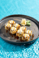 japanese cuisine sushi rolls on blue water background