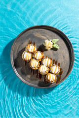 japanese cuisine sushi rolls on blue water background