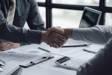 Obraz premium Two business people shake hands after a business deal is reached In the office area