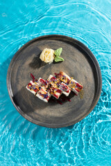 japanese cuisine sushi rolls on blue water background