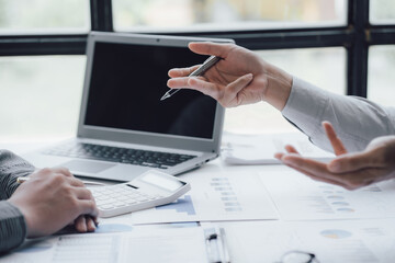 businessman working on desk office with using a calculator to calculate the numbers, finance accounting concept