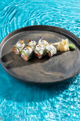 japanese cuisine sushi rolls on blue water background