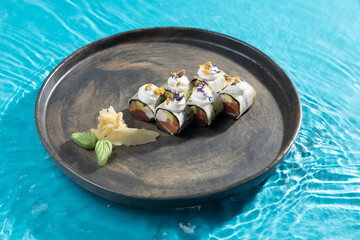 japanese cuisine sushi rolls on blue water background