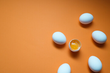 White eggs and egg yolk on the yellow background.