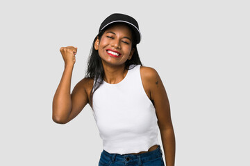 Young Indian woman cut out isolated on white background celebrating a victory, passion and enthusiasm, happy expression.