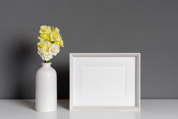 Blank landscape frame mockup with narcissus flowers