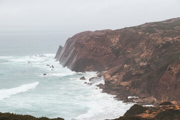 Stormy weather over the rocky cliffs of southwest Portugal's Algarve region. The power of the ocean. Wandering the Fisherman trail, Rota Vicentina