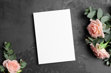Invitation or greeting card mockup with roses flowers on black background, mock up with copy space