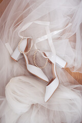 Fototapeta na wymiar Wedding white shoes of the bride. Wedding accessories