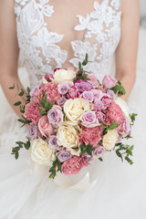Wedding beautiful bouquet of roses in the hands of the bride
