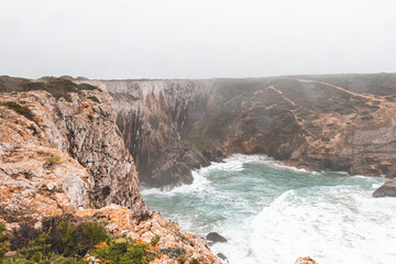 Rocky coastline of the Atlantic Ocean in the south-west of Portugal in the Algarve region. Exploring the beautiful rugged nature of the Fisherman Trail. Cape St. Vincent